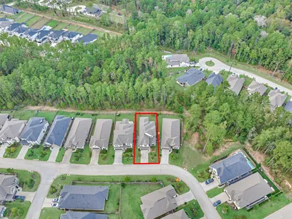 an aerial view of a house with garden space and street view