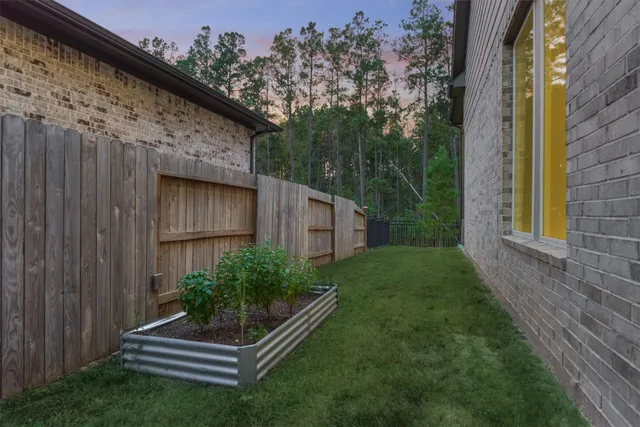 a backyard of a house with plants and outdoor seating