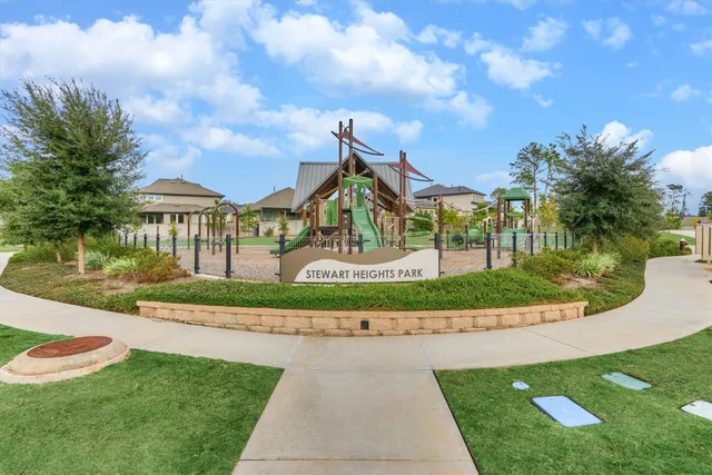 a view of a park with iron fence