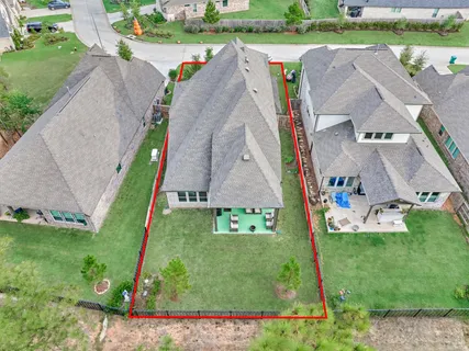 an aerial view of multiple houses with yard