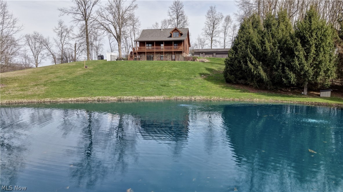 8045 McFadden Road Shreve, OH 44676 - Photo 7 of 45 Back of house featuring a water view and a yard