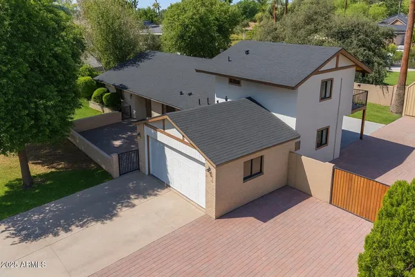 an aerial view of a house with a yard