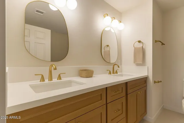 a bathroom with a double vanity sink and a mirror