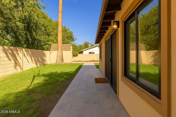 a view of a pathway of a house with a yard