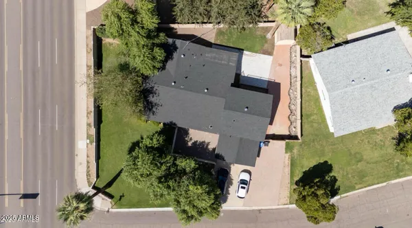 an aerial view of a house with a yard