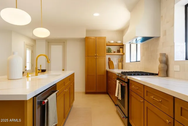 a kitchen with a sink stove and refrigerator