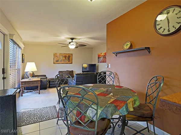 a view of a dining room with furniture and a chandelier