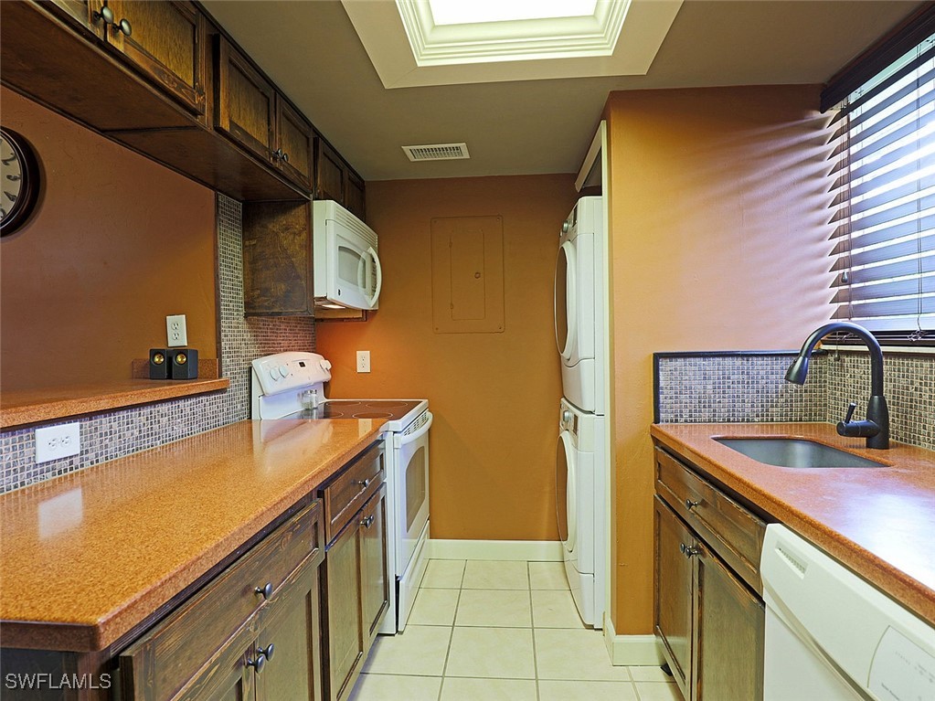 5804 Newfoundland Fort, Unit 1 Fort Myers, FL 33907 - Photo 13 of 29 a kitchen with a sink and cabinets