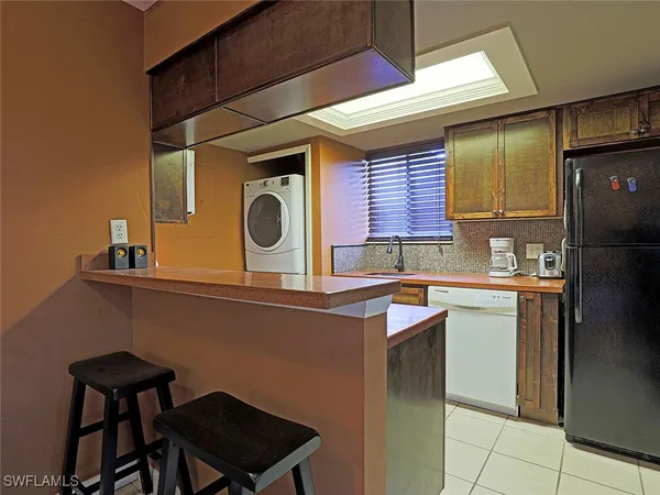 a kitchen with a sink cabinets and window
