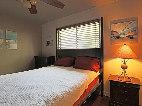 a bed sitting in a bedroom next to a window