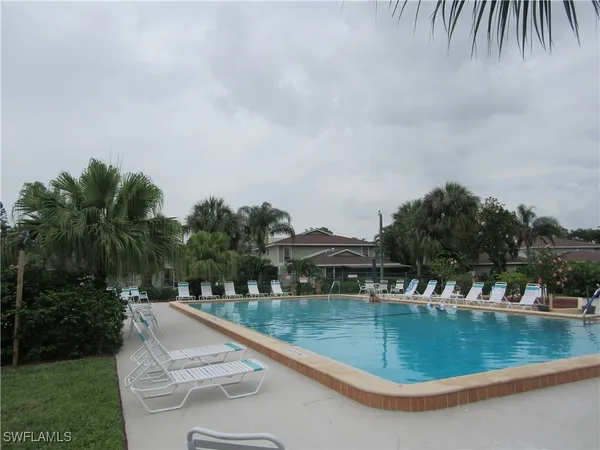 a view of a swimming pool with a yard