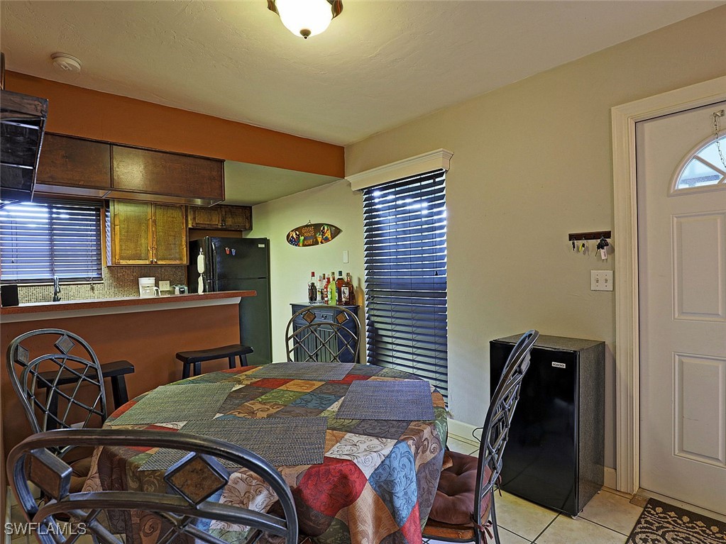 5804 Newfoundland Fort, Unit 1 Fort Myers, FL 33907 - Photo 9 of 29 a dining room with furniture and window