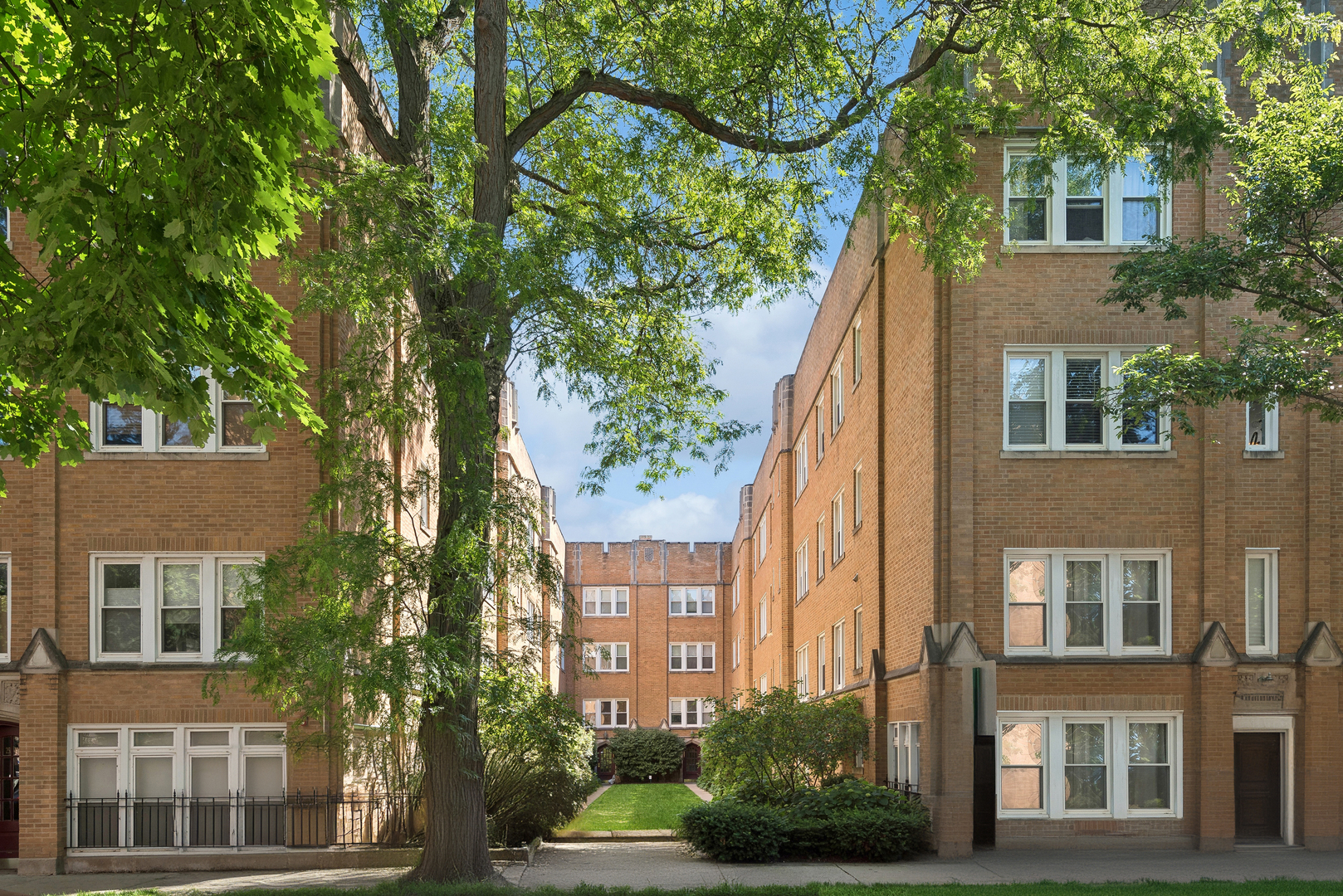 2539.5 Prairie Avenue, Unit 3E Evanston, IL 60201 - Photo 1 of 1 a view of a brick building next to a large tree