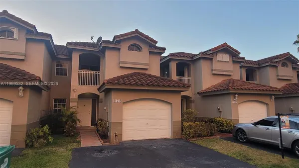 a front view of a house with parking