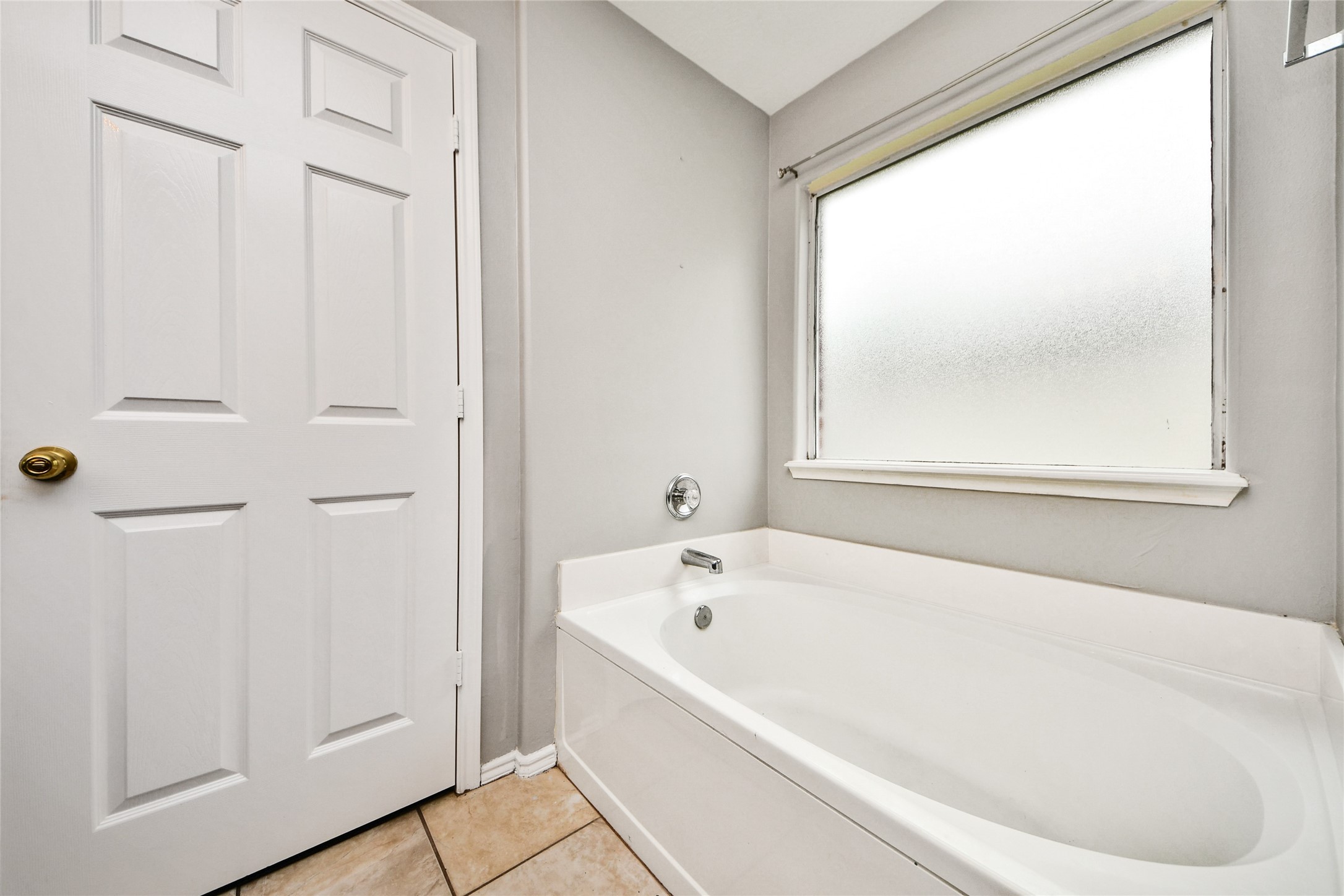 24019 Kingbriar Drive Spring, TX 77373 - Photo 34 of 41 The soaking tub is positioned under a frosted window that allows for natural light while maintaining complete privacy.