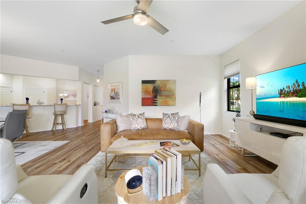 3787 Costa Maya Way, Unit 101 Estero, FL 33928 - Photo 12 of 49 Living area with wood finished floors and a ceiling fan