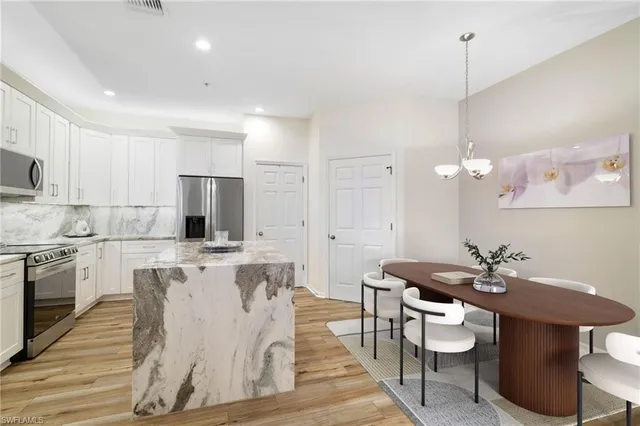a kitchen with a dining table chairs sink and stove