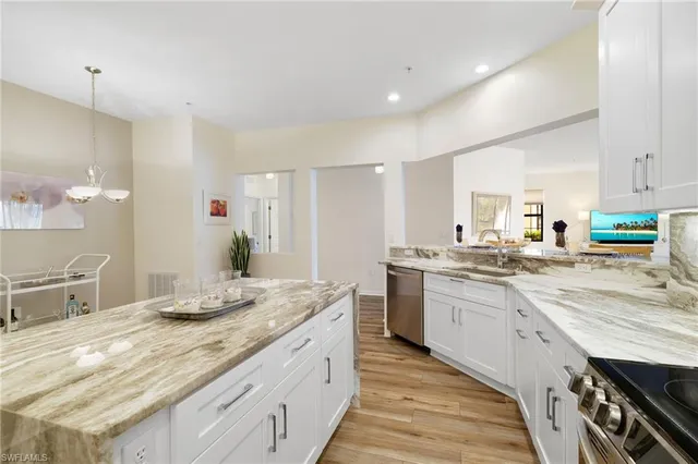 a kitchen with granite countertop a sink and cabinets