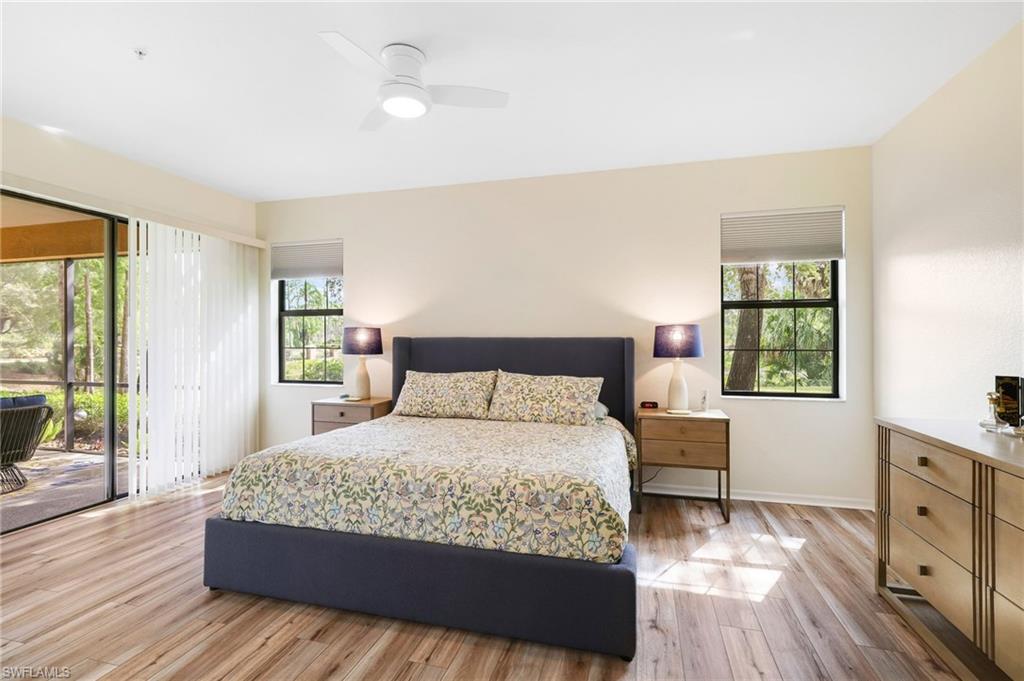 3787 Costa Maya Way, Unit 101 Estero, FL 33928 - Photo 20 of 49 Bedroom with access to exterior, light wood-style floors, and ceiling fan