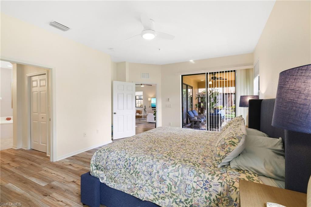 3787 Costa Maya Way, Unit 101 Estero, FL 33928 - Photo 21 of 49 Bedroom with light wood finished floors, access to exterior, and a ceiling fan