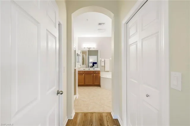 a view of a hallway with a dining room