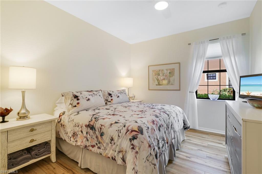 3787 Costa Maya Way, Unit 101 Estero, FL 33928 - Photo 25 of 49 Bedroom featuring light wood-style floors and a ceiling fan