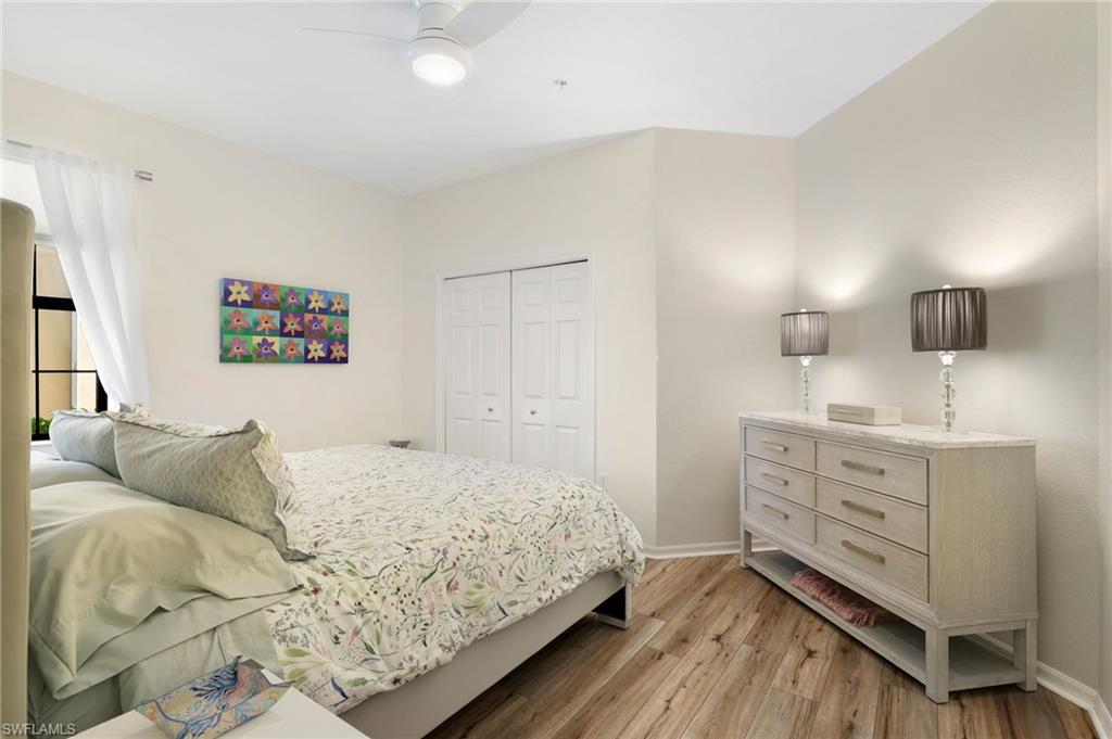 3787 Costa Maya Way, Unit 101 Estero, FL 33928 - Photo 26 of 49 Bedroom with light wood-type flooring, a closet, and ceiling fan