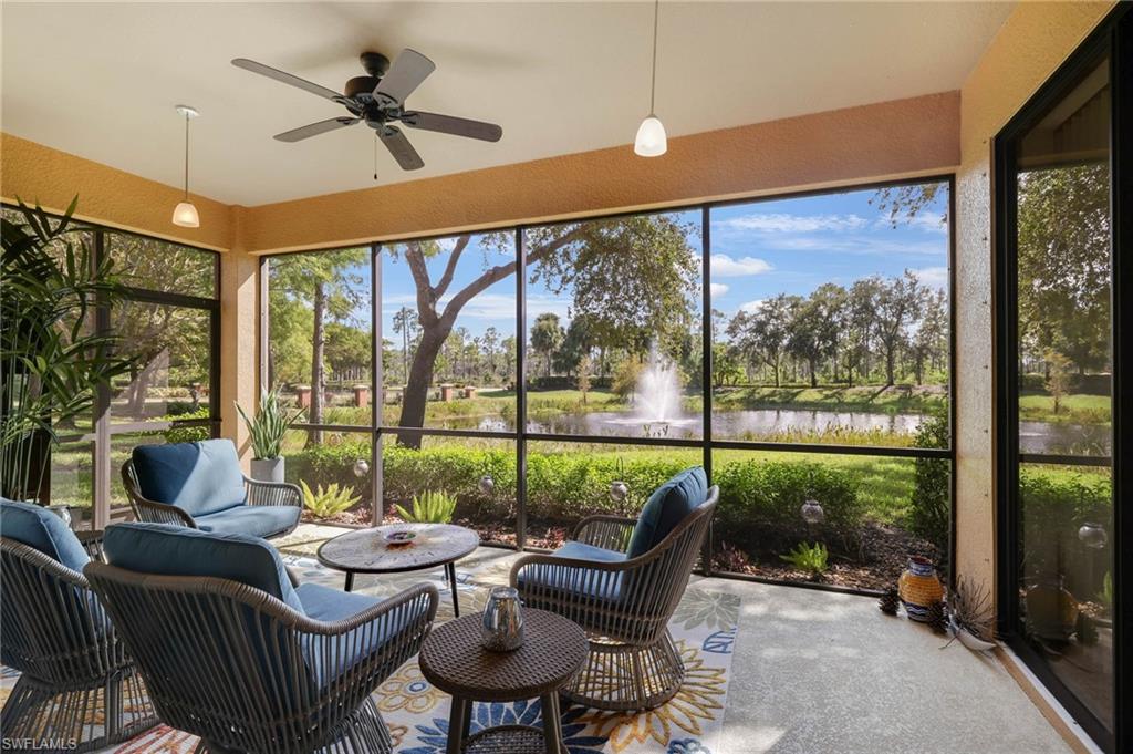 3787 Costa Maya Way, Unit 101 Estero, FL 33928 - Photo 30 of 49 Sunroom / solarium featuring a textured wall, a water view, ceiling fan, and an outdoor hangout area