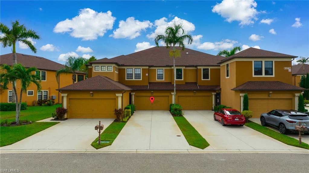 3787 Costa Maya Way, Unit 101 Estero, FL 33928 - Photo 32 of 49 View of front of home with stucco siding and concrete driveway