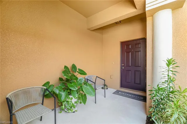 a green field with some trees in front of it