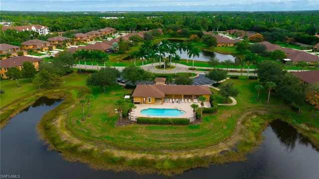 an aerial view of a house with a yard lake lake view