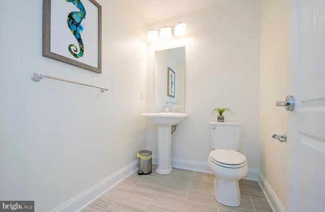 a view of roof deck with seating space and ocean view