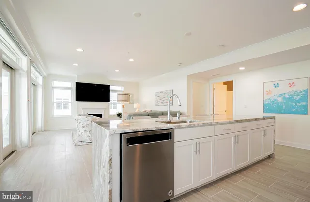 a bathroom with double vanity sinks granite tub and a large mirror