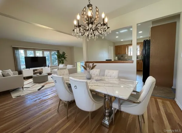 a view of a dining room with furniture wooden floor and chandelier