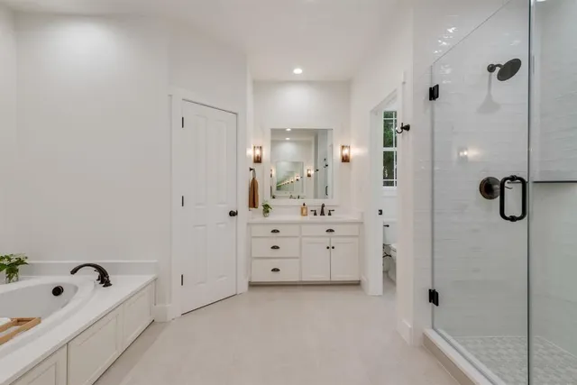 a bathroom with a tub sink and mirror