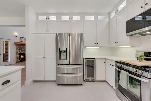 a kitchen with stainless steel appliances a refrigerator stove and microwave