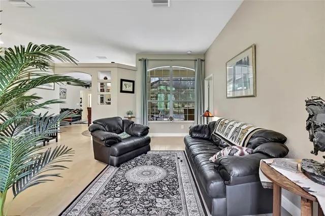 a living room with furniture ceiling fan and a rug