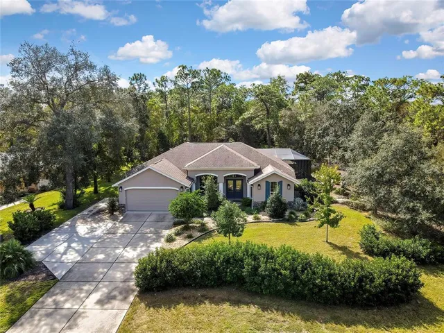 a view of a house with swimming pool and a yard
