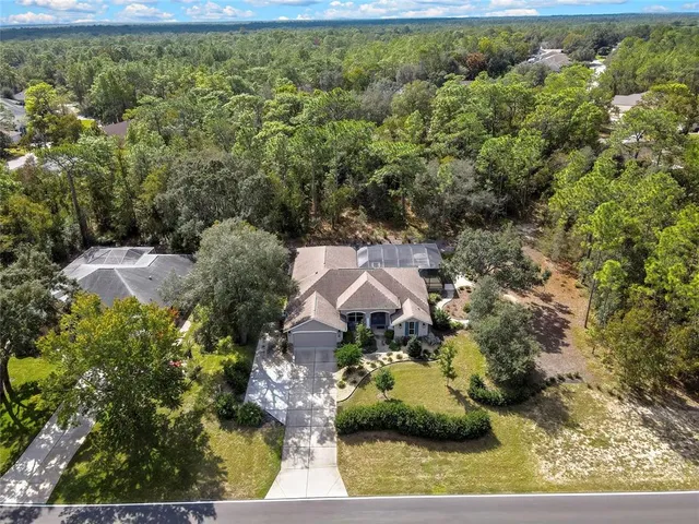 an aerial view of a house with a yard