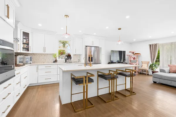 a kitchen with stainless steel appliances kitchen island granite countertop a sink and cabinets