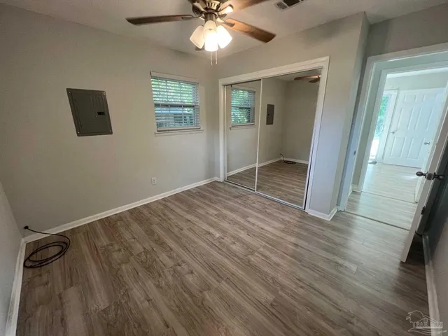 wooden floor in an empty room with a window