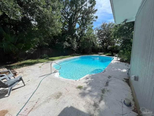 a view of a swimming pool with a yard