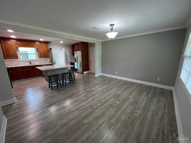 a view of a livingroom with furniture wooden floor and a window