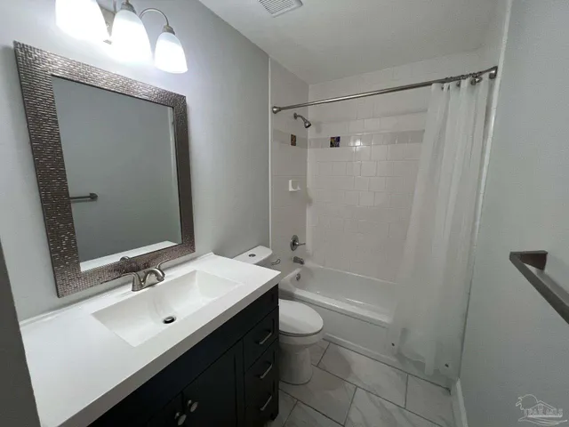 a bathroom with a double vanity sink toilet mirror and shower