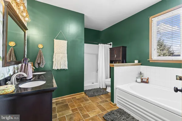 a spacious bedroom with a bed and a dresser