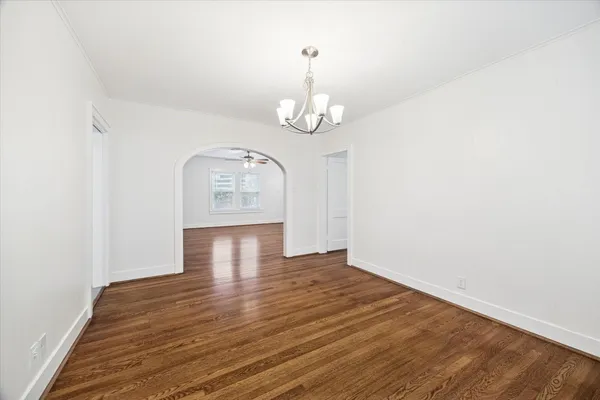 a view of a room with wooden floor and white walls
