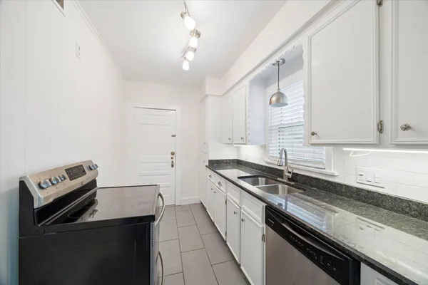a kitchen that has a sink and a stove