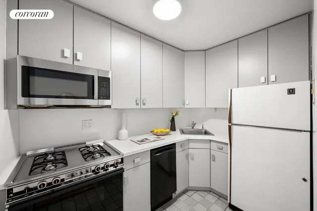 a view of a dining room with furniture and a potted plant