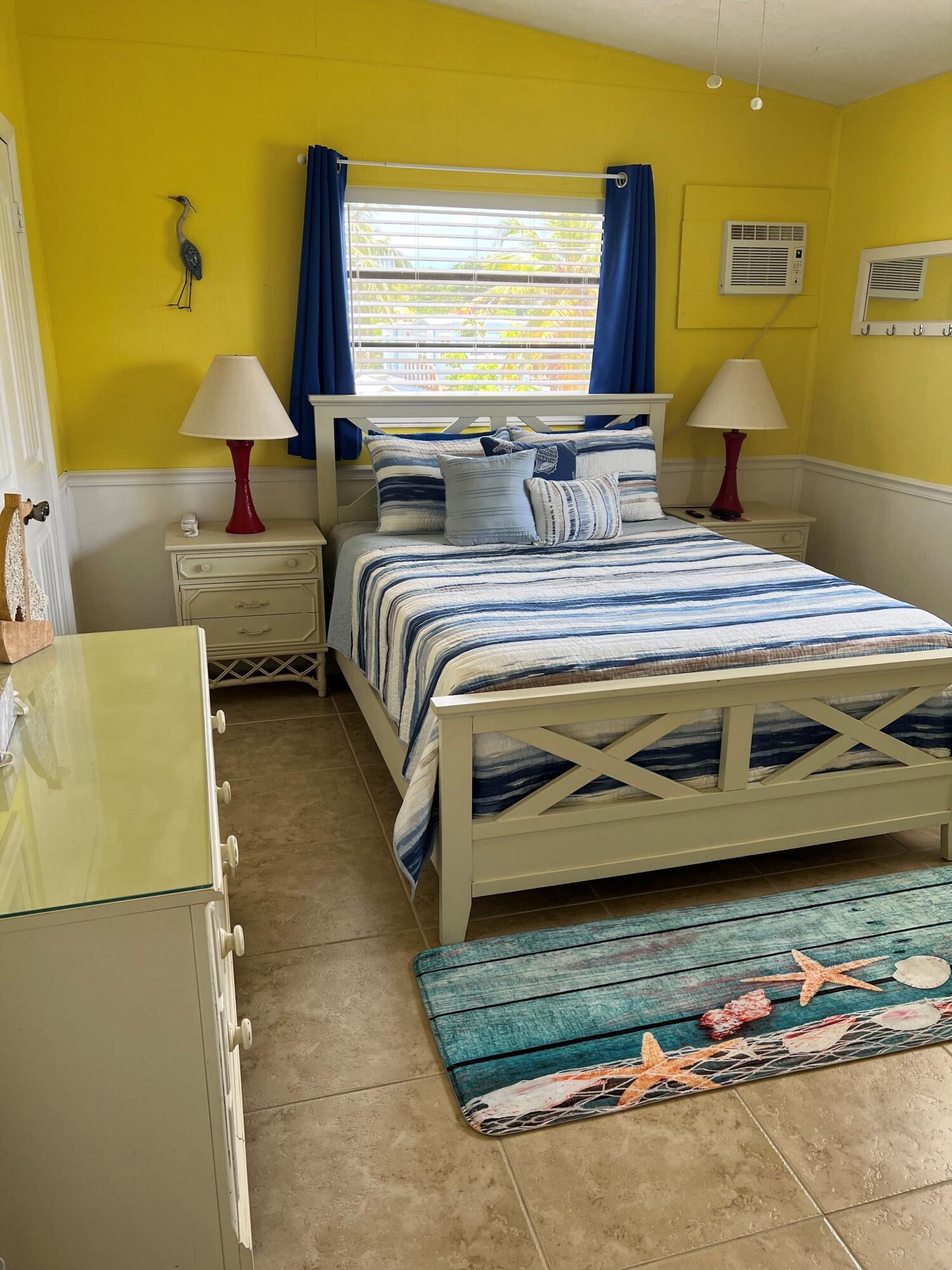 16 Shoreland Drive Key Largo, FL 33037 - Photo 13 of 16 a bedroom with a bed dresser and a window