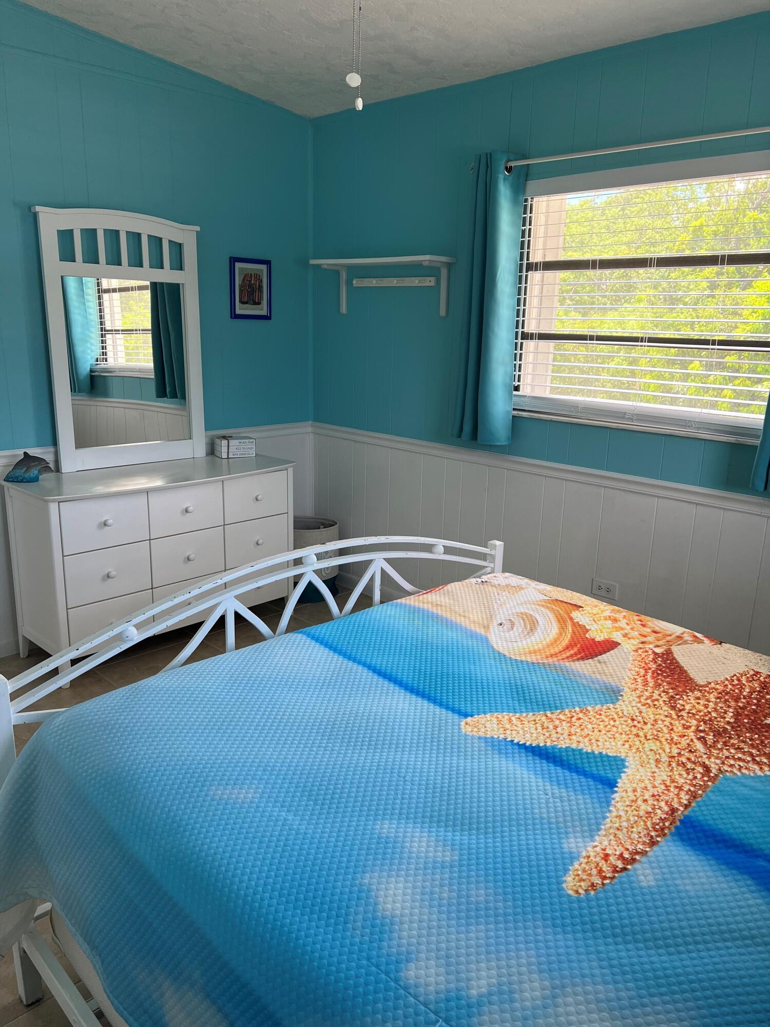 16 Shoreland Drive Key Largo, FL 33037 - Photo 14 of 16 a bedroom with a bed and a dresser